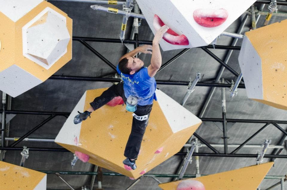 Alex climbing a bouldering competition wall